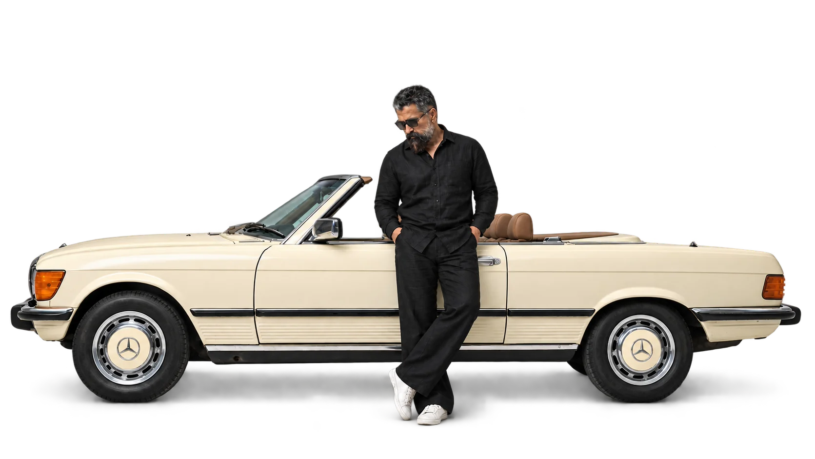 Parveen Verma, who designs every kit, leaning on a cream Mercedes-Benz convertible